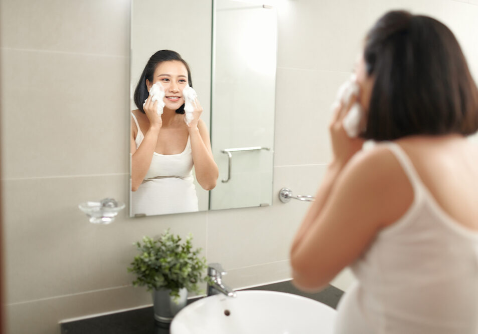 f beautiful pregnant woman washing her face in bathroom