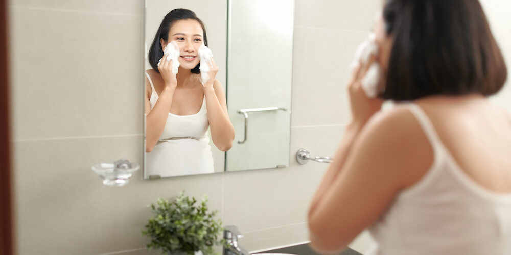 f beautiful pregnant woman washing her face in bathroom